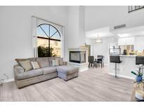 Bright living room features large windows, a fireplace, and an open floor plan at 500 N Roosevelt Ave # 53, Chandler, AZ 85226