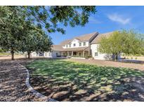 Stunning single-story home featuring a well-manicured lawn and mature trees at 856 W Quail Cir, San Tan Valley, AZ 85143