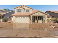 Charming two-story home featuring a neutral-tone facade, a two-car garage, and a well-maintained landscape at 1073 N 159Th Dr, Goodyear, AZ 85338