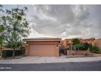 Inviting home featuring a two-car garage, desert landscaping, and a charming front entrance at 10830 N 11Th St, Phoenix, AZ 85020