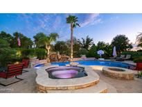 Backyard pool features a water slide, a hot tub, a fire pit, and a basketball hoop at 11307 E Elmhurst Dr, Chandler, AZ 85249