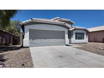 Charming home featuring a two-car garage and neutral gray and white color scheme at 11342 W Barbara Ave, Peoria, AZ 85345