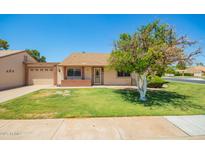 Single-story home featuring a well-manicured lawn, brick accents, and a charming orange tree in the front yard at 160 Leisure World -- # 160, Mesa, AZ 85206