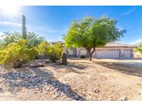Charming single-story home with desert landscaping and a three-car garage at 21 E Irvine Rd, Phoenix, AZ 85086