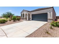 Charming single-story home with a two-car garage, desert landscaping, and a concrete driveway at 28512 N Geode Dr, San Tan Valley, AZ 85143