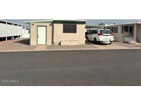 Modest home with a white door and single window, alongside a white minivan in the driveway at 300 S Val Vista Dr # 77, Mesa, AZ 85204