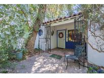Charming front entrance with a decorative wreath, iron gate, and mature landscaping at 3303 E Clarendon Ave, Phoenix, AZ 85018