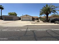Charming single-story home with desert landscaping, and a detached garage at 3827 E Sweetwater Ave, Phoenix, AZ 85032