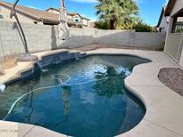 Relaxing backyard pool with waterfall feature, perfect for enjoying sunny days at 8820 W Glenn Dr, Glendale, AZ 85305