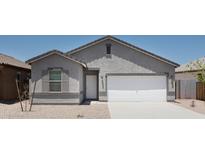 Charming single-story home with neutral stucco, attached two-car garage, and simple desert landscaping at 10314 S 58Th Ln, Laveen, AZ 85339
