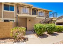 Charming condo with private balcony and landscaped front, offering a welcoming curb appeal in a well-maintained community at 1234 N 84Th Pl, Scottsdale, AZ 85257