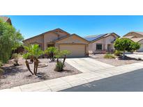 Charming single-story home featuring desert landscaping, a two-car garage, and a welcoming facade at 1384 S 222Nd Ln, Buckeye, AZ 85326