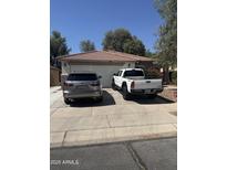 Charming single story home featuring a two car garage, front landscaping and desert landscaping at 15144 W Washington St, Goodyear, AZ 85338