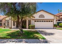 Charming single-story home with a well-maintained lawn and a two-car garage at 2137 E New Bedford Dr, Gilbert, AZ 85234