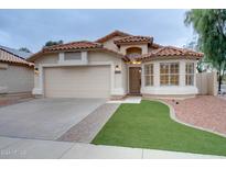Charming single-story home featuring a red tile roof and a well-manicured lawn at 2203 E Crest Ln, Phoenix, AZ 85024