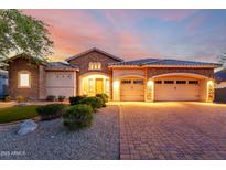 Charming single-Gathering home with a three car garage, stone accents, and manicured landscaping in front yard at 31502 N 58Th Pl, Cave Creek, AZ 85331