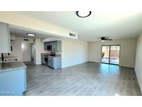 Bright living room with modern flooring leading to the kitchen and outdoor space, perfect for entertaining at 3708 W Peoria Ave, Phoenix, AZ 85029