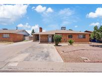 Charming brick home with a well-maintained yard and driveway, perfect for a Gathering at 4026 W Berridge W Ln, Phoenix, AZ 85019