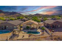 Inviting backyard with a sparkling pool, spa, and covered patio, perfect for outdoor relaxation and entertaining at 4297 S Pony Rider Trl, Gold Canyon, AZ 85118