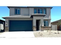 Two-story home featuring a two-car garage, neutral stucco exterior, and a covered front entryway at 5669 S 253Rd Ave, Buckeye, AZ 85326