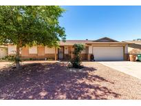 Charming single-story home featuring a low maintenance yard and a two-car garage at 617 E Calle Adobe Ln, Goodyear, AZ 85338