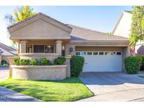 Charming single-story home featuring a front yard with manicured landscaping and a two-car garage at 7525 E Gainey Ranch Rd # 164, Scottsdale, AZ 85258