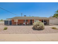 Charming brick home featuring a covered carport and a low-maintenance desert landscape at 8155 E Columbus Ave, Scottsdale, AZ 85251