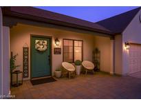 Inviting front entrance with charming decor, including a wreath and a 'HOME' sign and a seating area at 1401 E Drake Dr, Tempe, AZ 85283