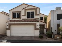 Charming two-story home featuring a red tile roof and a two-car garage at 2339 E Evans Dr, Phoenix, AZ 85022