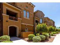 Charming multi-story townhome featuring well-maintained landscaping and a welcoming entrance at 240 W Juniper Ave # 1211, Gilbert, AZ 85233