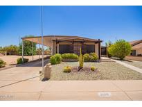 Charming home featuring desert landscaping, a covered carport, and a unique architectural style at 2529 N Barber Dr, Mesa, AZ 85215