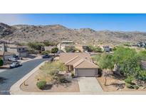 Charming one-story home with a two-car garage and desert landscaping against a mountain backdrop at 3441 E Melody Dr, Phoenix, AZ 85042