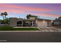 Stunning modern home with unique architectural design, fresh grass, and professional landscaping at 4202 E Catalina Dr, Phoenix, AZ 85018
