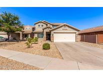 Charming two-story home boasts desert landscaping, a two-car garage, and a classic tile roof at 509 S 111Th Dr, Avondale, AZ 85323