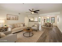 Inviting living room with a ceiling fan, comfortable seating, and views of the dining area at 5104 N 32Nd St # 114, Phoenix, AZ 85018