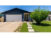 Charming home featuring an attached garage, front yard landscaping, and a welcoming entrance at 5432 W Sunnyside Dr, Glendale, AZ 85304