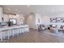 Open concept living room featuring modern decor, light wood floors, and bright, neutral color palette at 9835 E Wavelength Ave, Mesa, AZ 85212