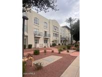 Condominium building featuring balconies, desert landscaping, and pedestrian walkways at 1081 W 1St St # 10, Tempe, AZ 85281
