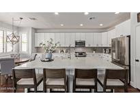 Bright kitchen featuring a spacious island, white cabinets, and stainless steel appliances at 1342 E Jade Dr, Chandler, AZ 85286