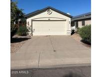 Charming single-story home featuring a two-car garage and well-maintained front yard at 15088 N 85Th Dr, Peoria, AZ 85381