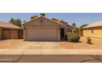 Charming single-story home with a neutral color scheme, tile roof, and a two-car garage at 15737 W Lundberg St, Surprise, AZ 85374