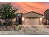 Charming single-Gathering home featuring a two-car garage, desert landscaping and neutral-toned exterior paint at 1783 W Cool Water Way, San Tan Valley, AZ 85144
