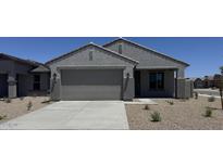 Charming single-story home featuring a stucco exterior, attached garage, and low-maintenance desert landscaping at 18340 W Patrick Ln, Surprise, AZ 85387