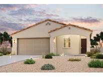 Charming single-story home featuring a neutral color scheme, well-manicured landscaping, and a two-car garage at 1989 S 246Th Ln, Buckeye, AZ 85326