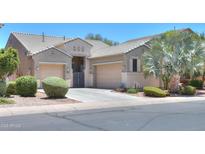 Charming single-Gathering home features a well-manicured front yard and a convenient two-car garage at 19969 N Santa Cruz Dr, Maricopa, AZ 85138