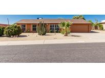 Charming single story home with desert landscaping, including mature cacti and shrubs at 2437 E North Ln, Phoenix, AZ 85028