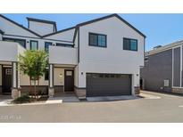 Modern two-story home featuring a gray two-car garage, and neutral color scheme at 2604 N 27Th St # 17, Phoenix, AZ 85008