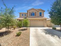 Charming two-story home featuring a well-manicured front yard, neutral tones and a two car garage at 297 W Tamarack Dr, San Tan Valley, AZ 85140