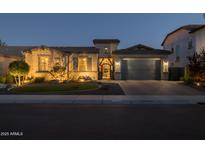Charming single-Gathering home featuring stone accents, tiled roof, well-manicured lawn, and a two-car garage, perfect for comfortable living at 3049 E Longhorn Dr, Gilbert, AZ 85297
