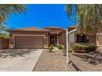 Single-story home with a tile roof, two-car garage, and desert landscaping for low maintenance at 3622 E Sparrow Pl, Chandler, AZ 85286